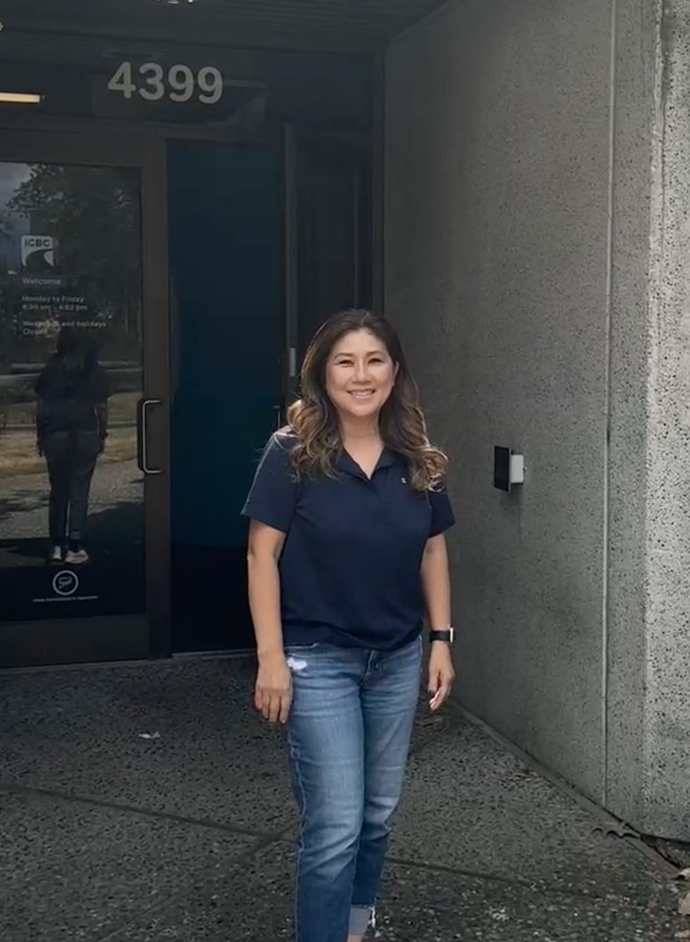 Grace, Burnaby driving instructor, standing beside her lesson vehicle